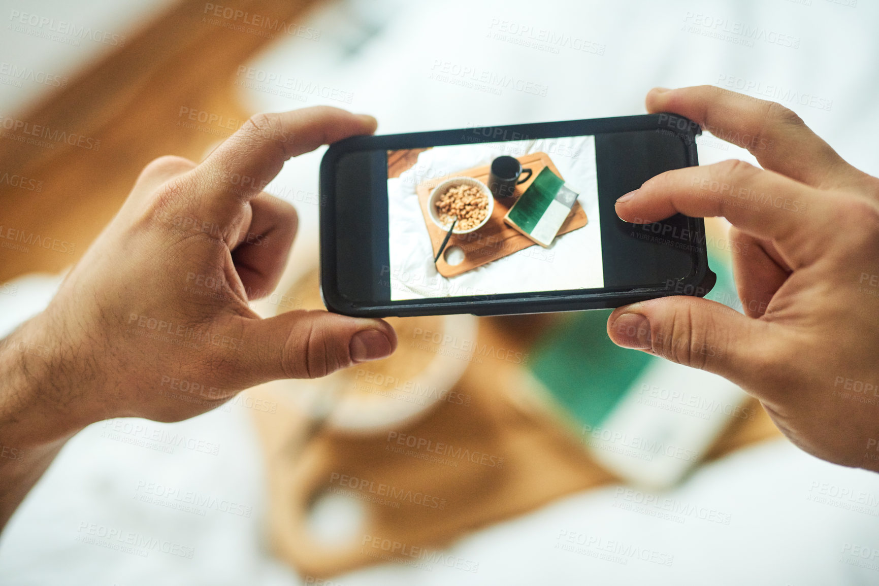 Buy stock photo High angle shot of an unrecognizable man taking a picture of his breakfast in bed at home
