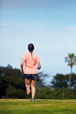 Buy stock photo Rearview shot of an unrecognizable woman running outside