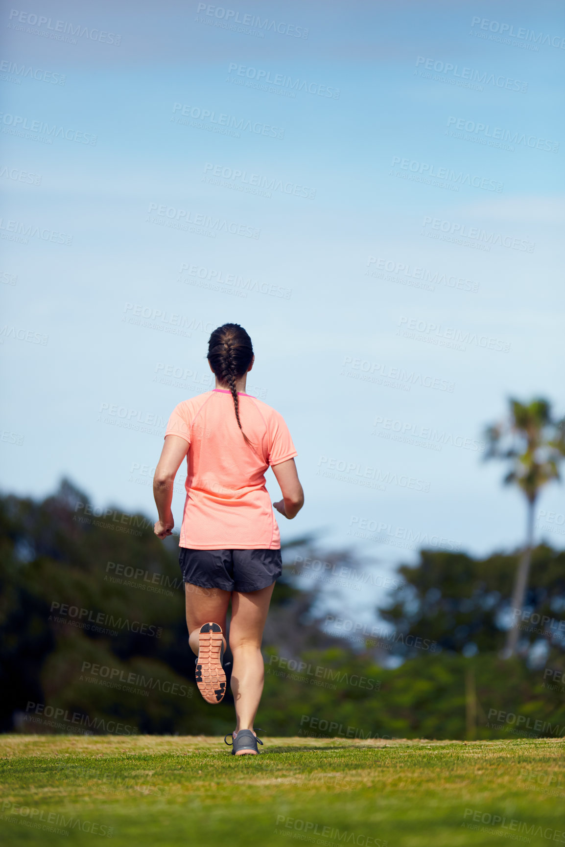 Buy stock photo Rearview shot of an unrecognizable woman running outside