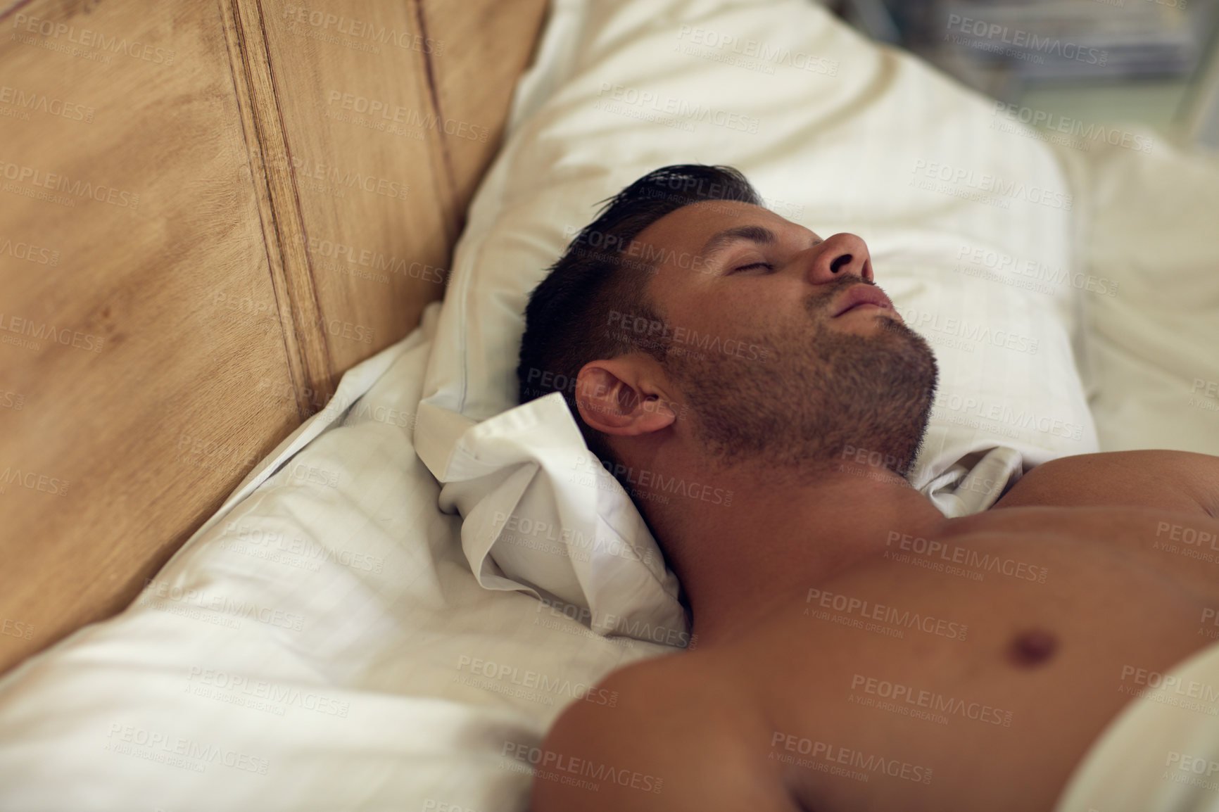 Buy stock photo Cropped shot of young handsome man sleeping in bed at home