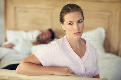 Buy stock photo Cropped shot of a married couple having a disagreement in the bedroom at home
