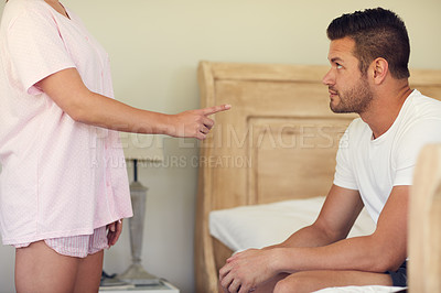 Buy stock photo Cropped shot of an unrecognizable woman having an argument with her husband in the bedroom at home