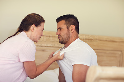 Buy stock photo Cropped shot of a married couple having an argument in the bedroom at home