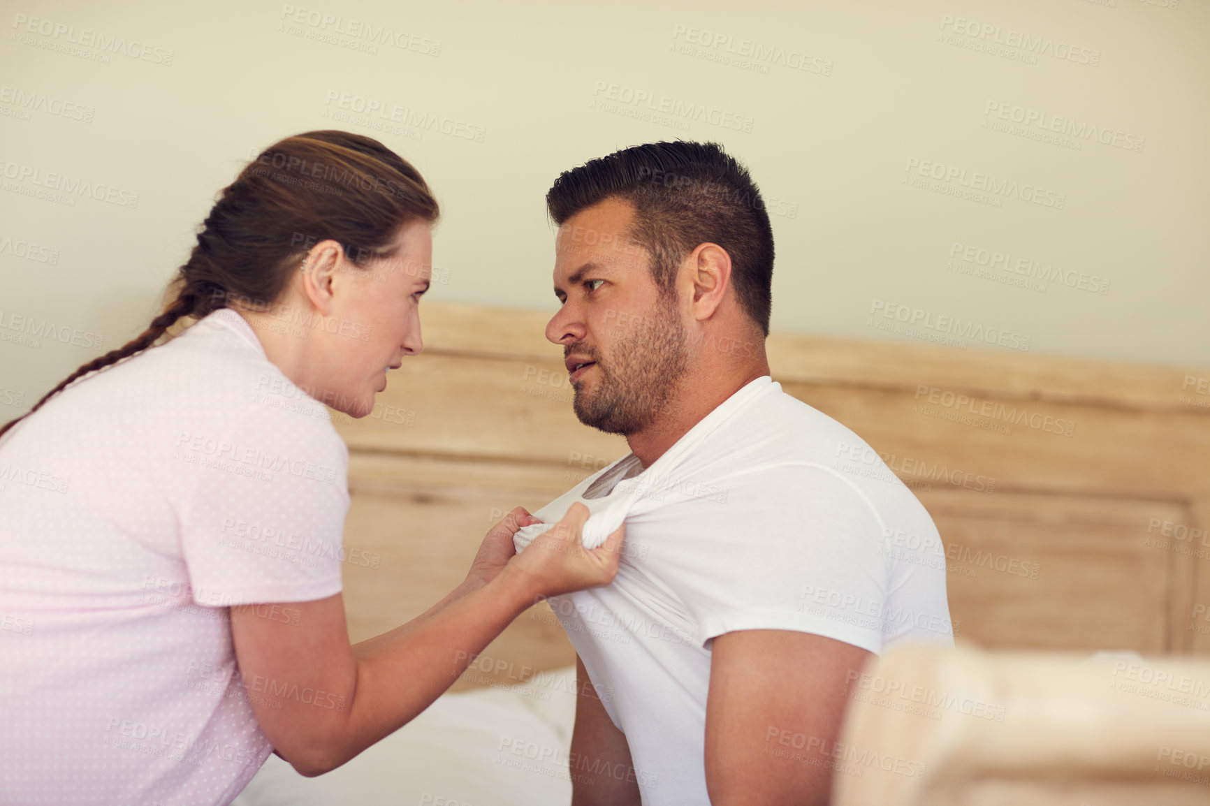 Buy stock photo Cropped shot of a married couple having an argument in the bedroom at home