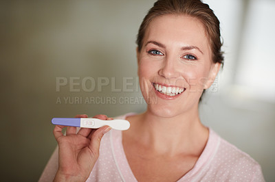 Buy stock photo Portrait of a young attractive woman holding a pregnancy stick in the bathroom at home