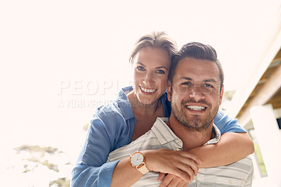 Buy stock photo Cropped shot of a young handsome man giving his beautiful wife a piggyback ride outside