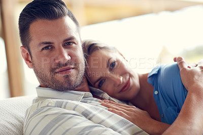 Buy stock photo Cropped shot of a young attractive wife lying on her husband's chest in the living room at home