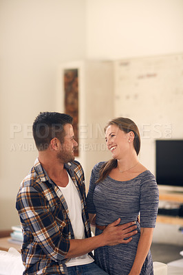 Buy stock photo Cropped shot of a young married couple spending the day at home