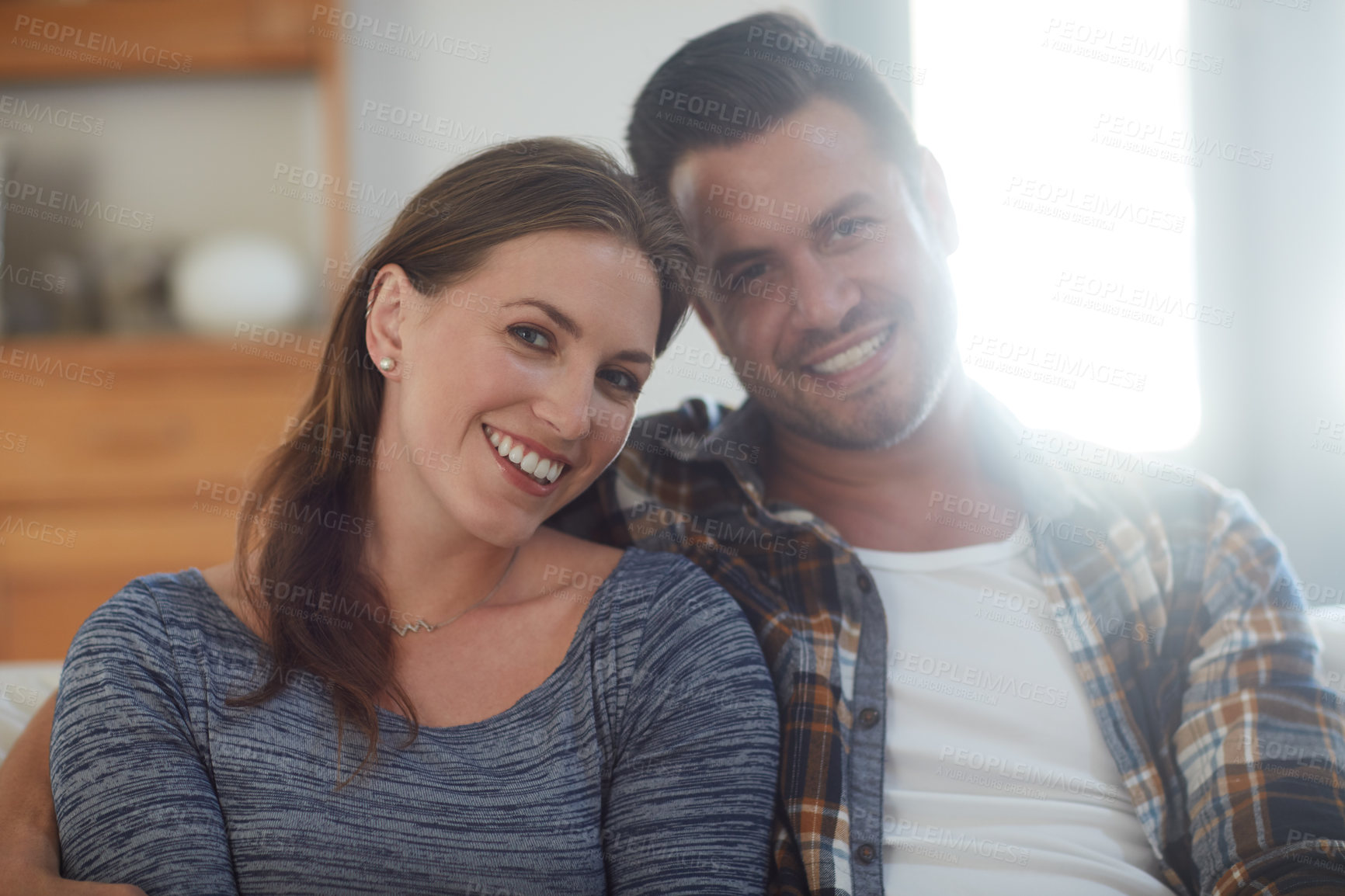 Buy stock photo Portrait of a young married couple spending the day at home
