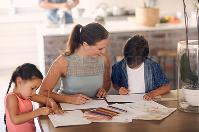 Buy stock photo Shot of a single mother helping her children with their homework
