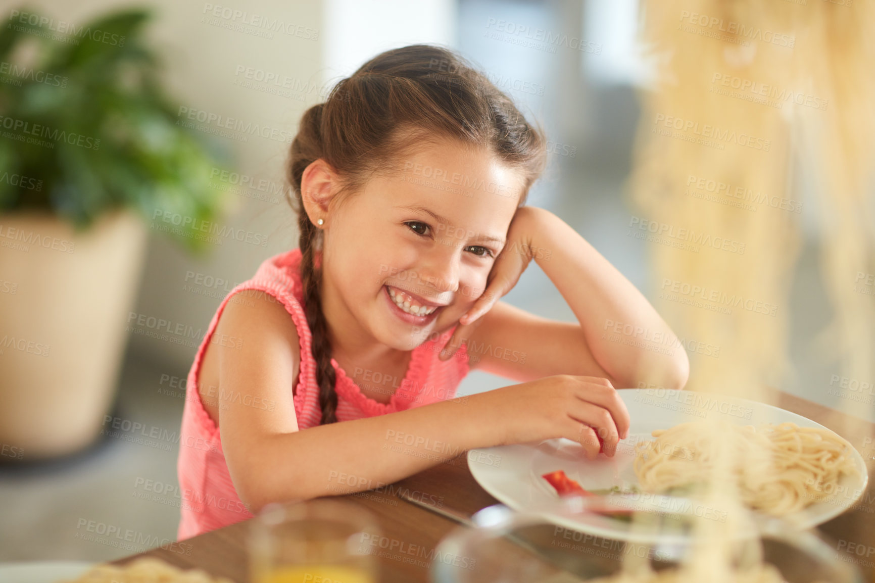 Buy stock photo Cropped shot of an adorable little girl eating her food at home