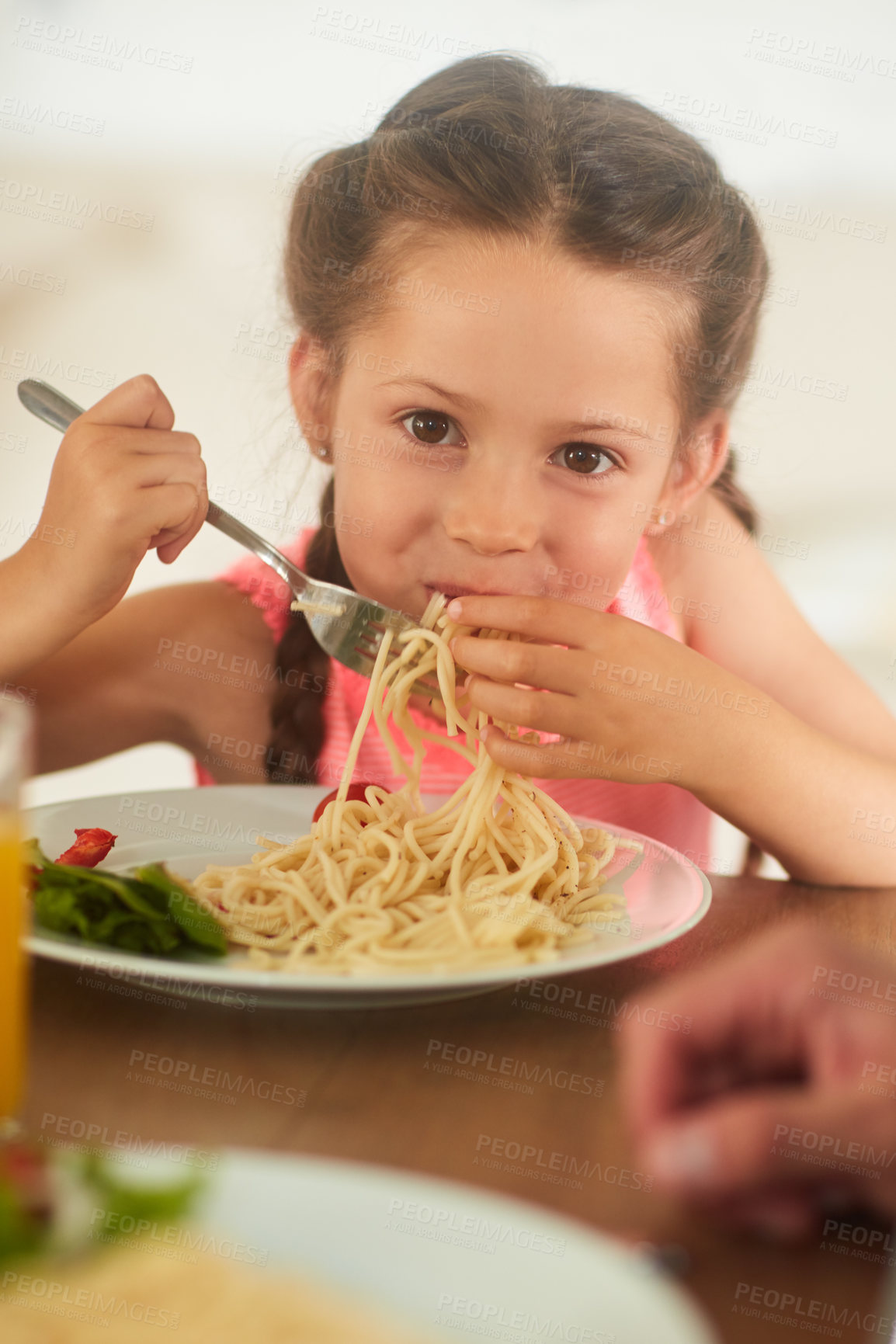 Buy stock photo Cropped shot of an adorable little girl eating her food at home