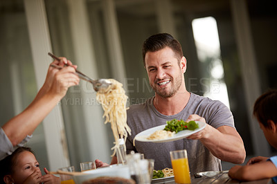 Buy stock photo Cropped shot of a family of four sitting down for a meal at home