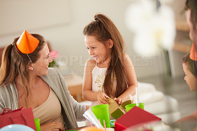 Buy stock photo Shot of a mother and daughter together at a birthday party
