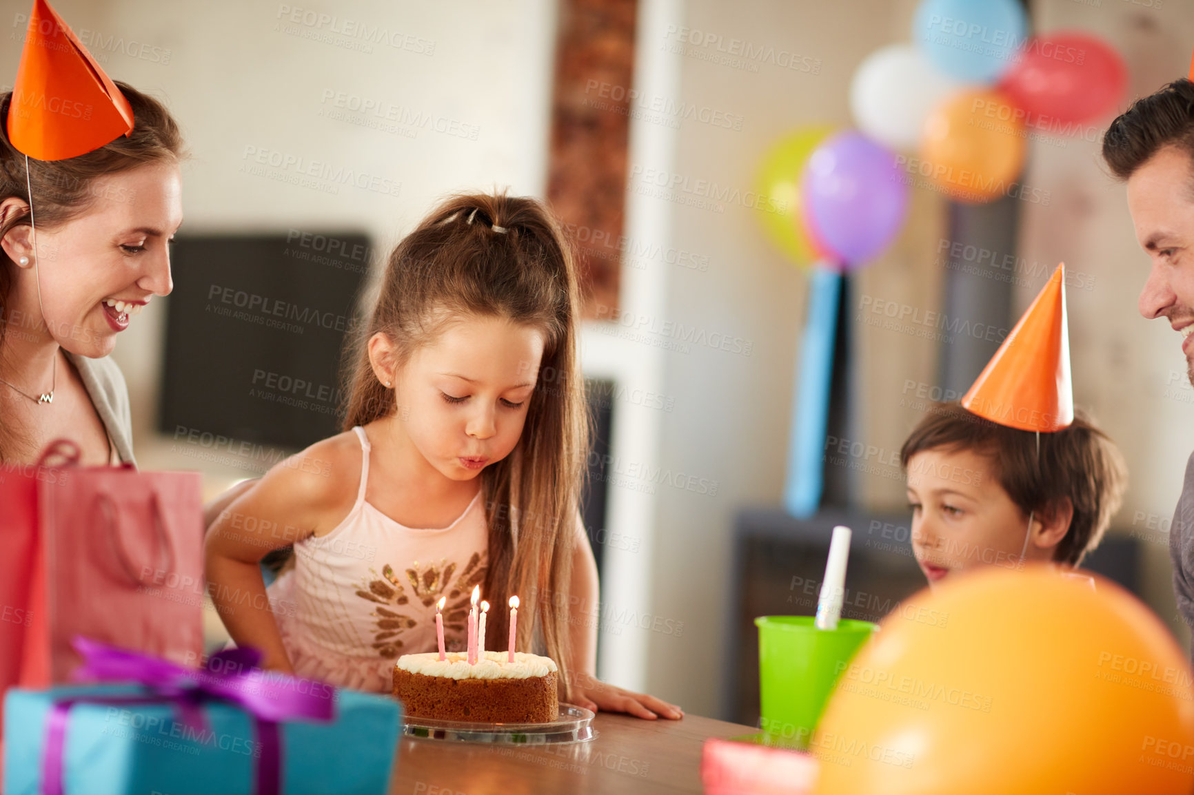 Buy stock photo Cropped shot of a family celebrating a birthday at home