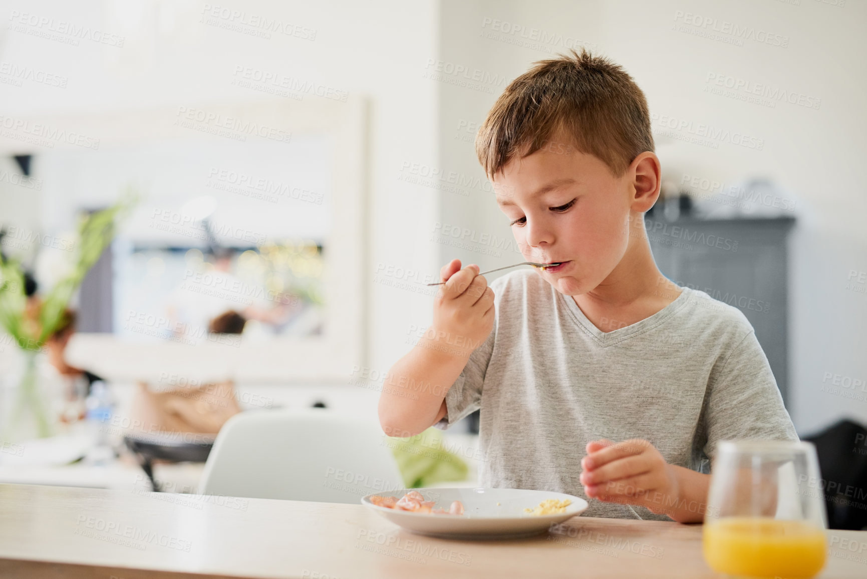 Buy stock photo Shot of an adorable little boy having breakfast at home