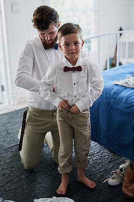 Buy stock photo Shot of an adorable little boy and his father getting dressed in matching outfits