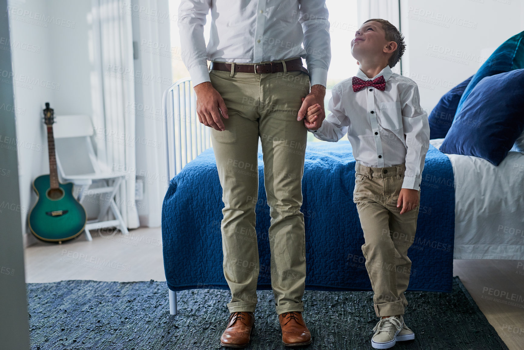 Buy stock photo Holding hands, fashion and dad with child in bedroom with matching outfit, formal clothes and bowtie. Family, morning routine and father with young boy in style for event, bonding and care in home