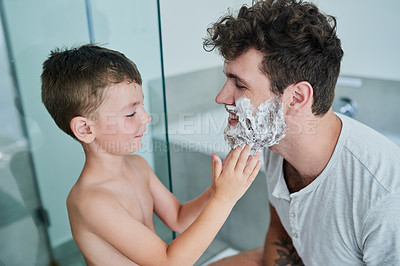 Buy stock photo Father, kid and learning how to shave in bathroom, having fun or bonding together. Smile, child and dad teaching with shaving cream on face, playing and cleaning, hygiene and enjoying quality time.