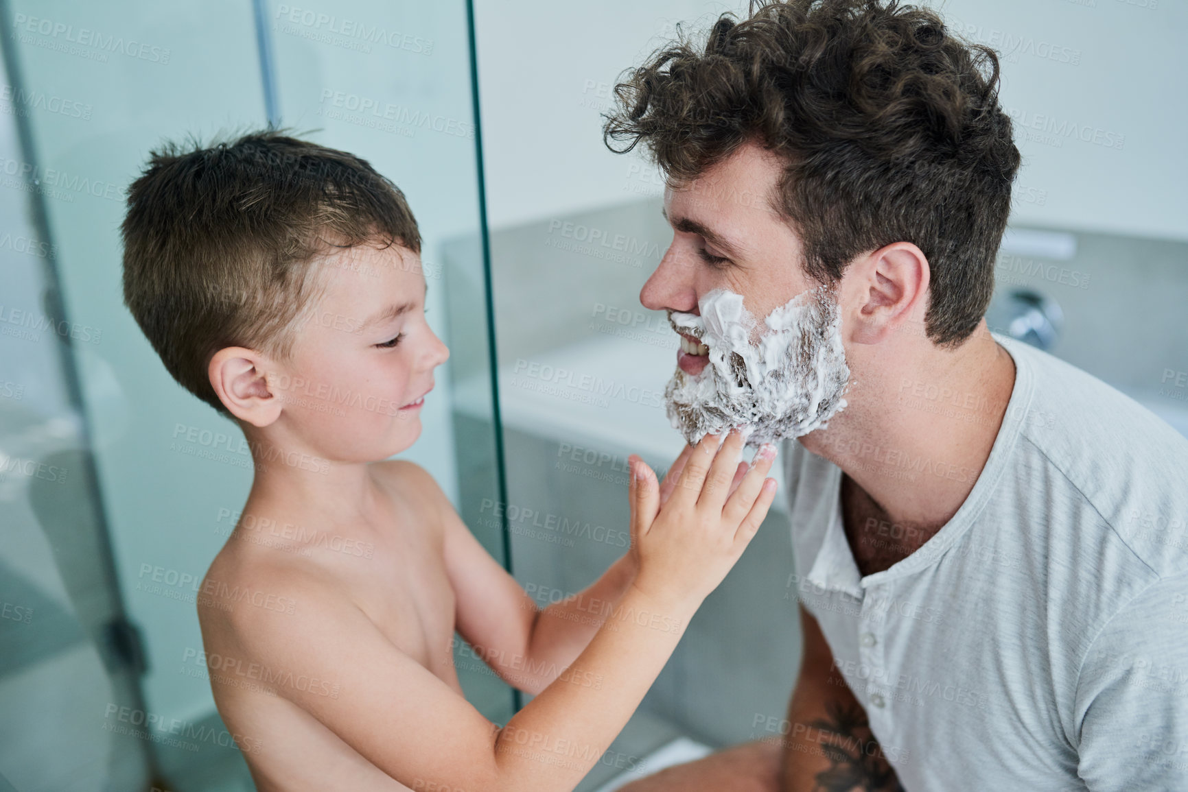 Buy stock photo Father, kid and learning how to shave in bathroom, having fun or bonding together. Smile, child and dad teaching with shaving cream on face, playing and cleaning, hygiene and enjoying quality time.