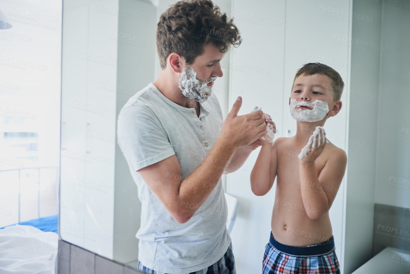 Buy stock photo Father, kid and learning to shave in bathroom, education and bonding together. Care, dad and teaching child with shaving cream on face, playing or cleaning, hygiene or enjoying hair removal in home.
