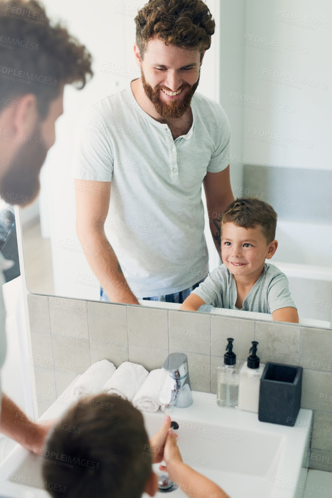 Buy stock photo Cropped shot of a young handsome father helping his adorable little boy wash his hands in the bathroom at home