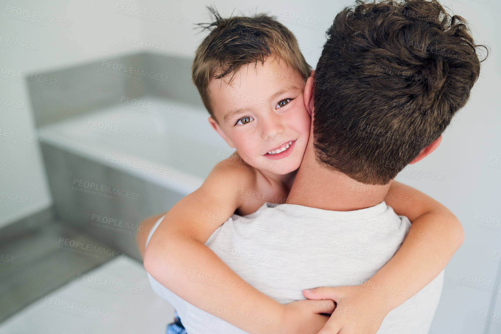 Buy stock photo Cropped shot of an unrecognizable father hugging his adorable little boy in the bathroom at home