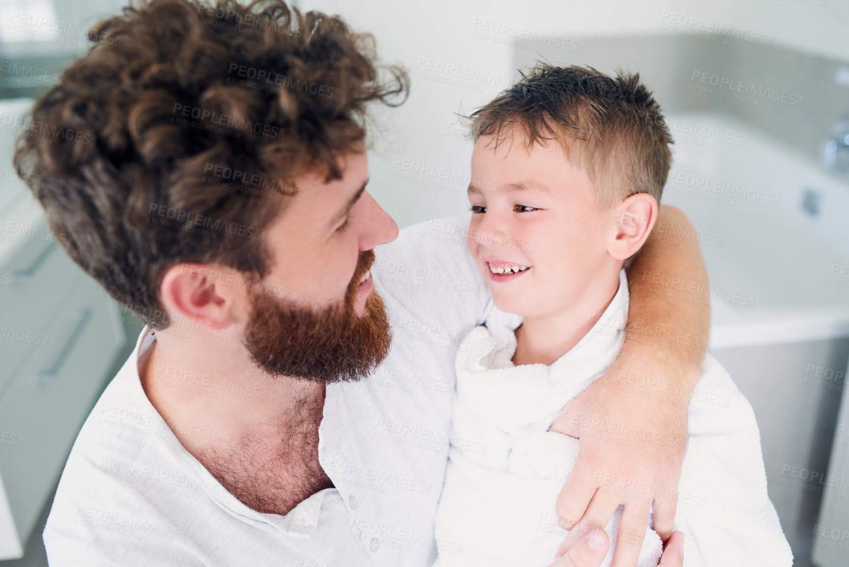 Buy stock photo Cropped shot of a young handsome father drying his adorable little son after a bath in the bathroom at home