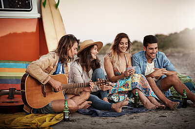 Buy stock photo Cropped shot of a group of friends hanging out together on the beach