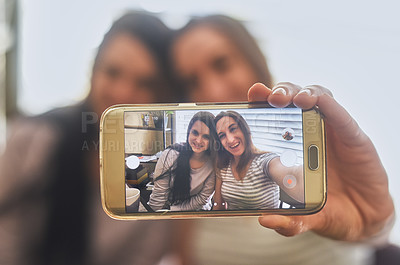 Buy stock photo Cropped shot of a two young women taking a picture in the morning at home