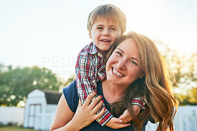 Buy stock photo Portrait of a mother giving her adorable little son a piggyback ride in the backyard at home