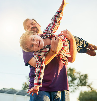 Buy stock photo Cropped shot of a father and son playing in the backyard at home