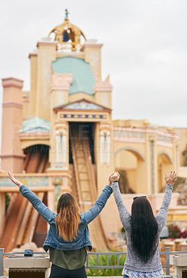 Buy stock photo Excited, freedom and back of friends at amusement park for adventure, carnival fair and ride attractions. Festival, happiness and holding hands with people for travel, parade and celebration 