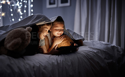 Buy stock photo Night, tablet and siblings in bed, home or watching a movie, film or cartoon with happiness. Children, kids or brother with sister, technology or online games with a smile, dark or relax in a bedroom