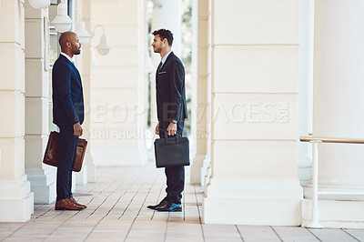 Buy stock photo Shot of two businessmen talking in the city