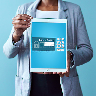 Buy stock photo Studio shot of an unrecognizable woman holding a tablet displaying an internet banking webpage against a blue background