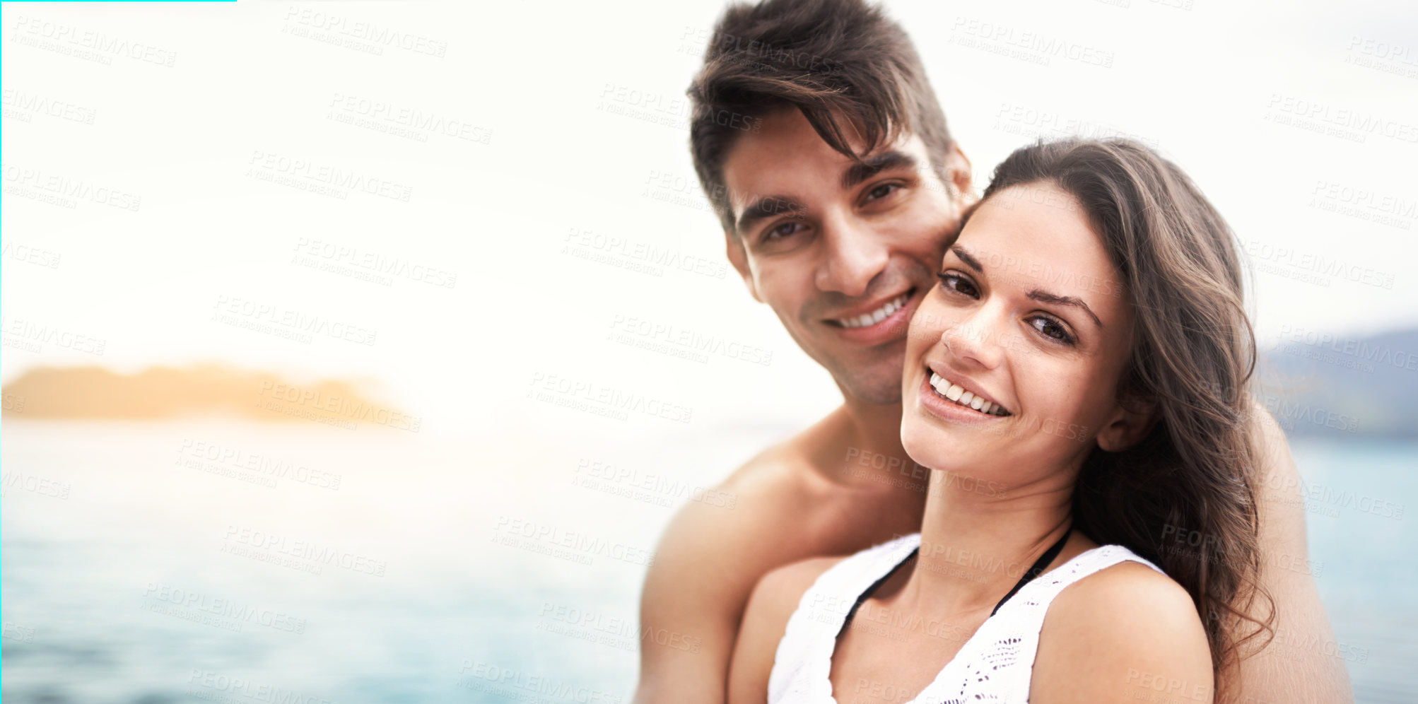 Buy stock photo Love, portrait and happy couple at beach with care, security and bonding on vacation together. Nature, summer or young people or fun at sea for travel, holiday or adventure on romantic date in Spain