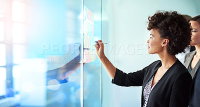 Buy stock photo Shot of colleagues having a brainstorming session at work