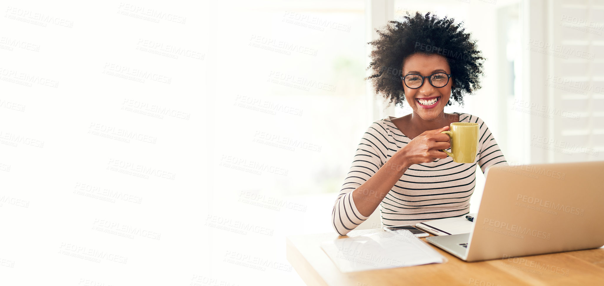 Buy stock photo Cropped portrait of a young woman drinking coffee while working on her laptop at home