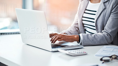 Buy stock photo Female accountant typing on a laptop in her office or doing research on the internet while sitting at a desk. Closeup of a financial advisor working on a project or business proposal at her workplace