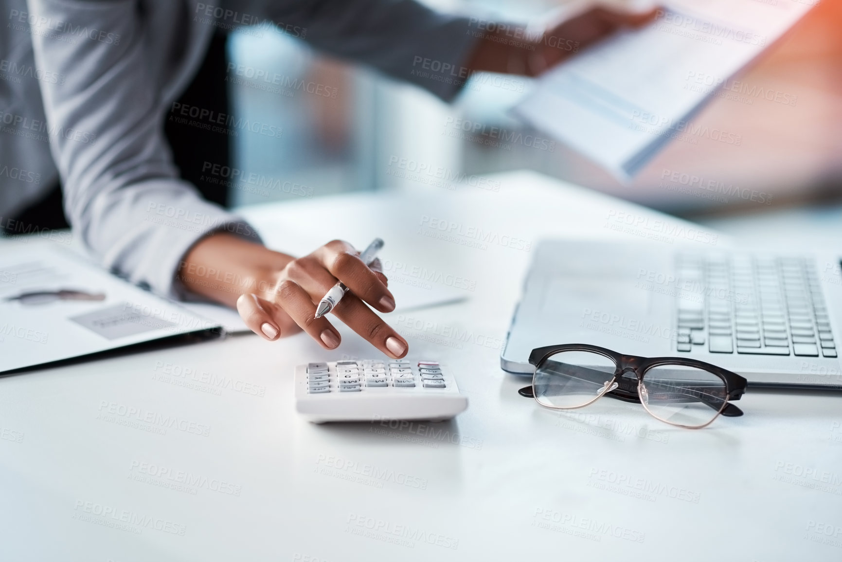 Buy stock photo Accountant, businesswoman or banker using calculator, checking paperwork and documents while preparing financial data report in an office. Hands of a woman doing payroll or calculating annual tax