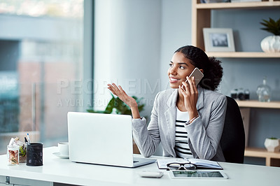 Buy stock photo Young business woman on a phone call talking and planning while sitting alone at a desk on a office computer. Female worker discussing work on her smartphone. An employee embracing modern technology