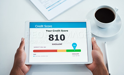 Buy stock photo Good and positive credit score on the screen of a tablet from above. Applying for finance, a loan or a home mortgage bond online. Closeup of hands holding a wireless device while banking on the web
