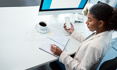 Buy stock photo Entrepreneur, secretary and admin assistant holding phone while writing down appointments, schedule and business contacts at her desk. Professional woman doing online research and making notes