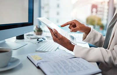 Buy stock photo Businessperson hands working on a digital tablet at a desk in a modern office. Closeup of business professional multitasking documents or checking data, schedule and daily plan at the workplace.