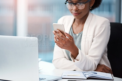 Buy stock photo Business woman with a phone texting, browsing and searching social media while working in the office. Creative agent checking schedule list, multitasking and managing goals and tasks on technology