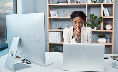 Buy stock photo Young confident, focused and thinking businesswoman sitting alone in an office and browsing the internet on a computer. Ambitious creative professional planning and thinking of ideas at a desk