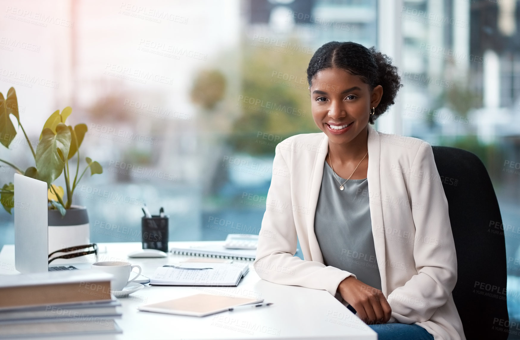 Buy stock photo Young, confident and ambitious business woman and corporate professional looking happy, positive and smiling in her office at work. Portrait of a female creative designer sitting at her desk