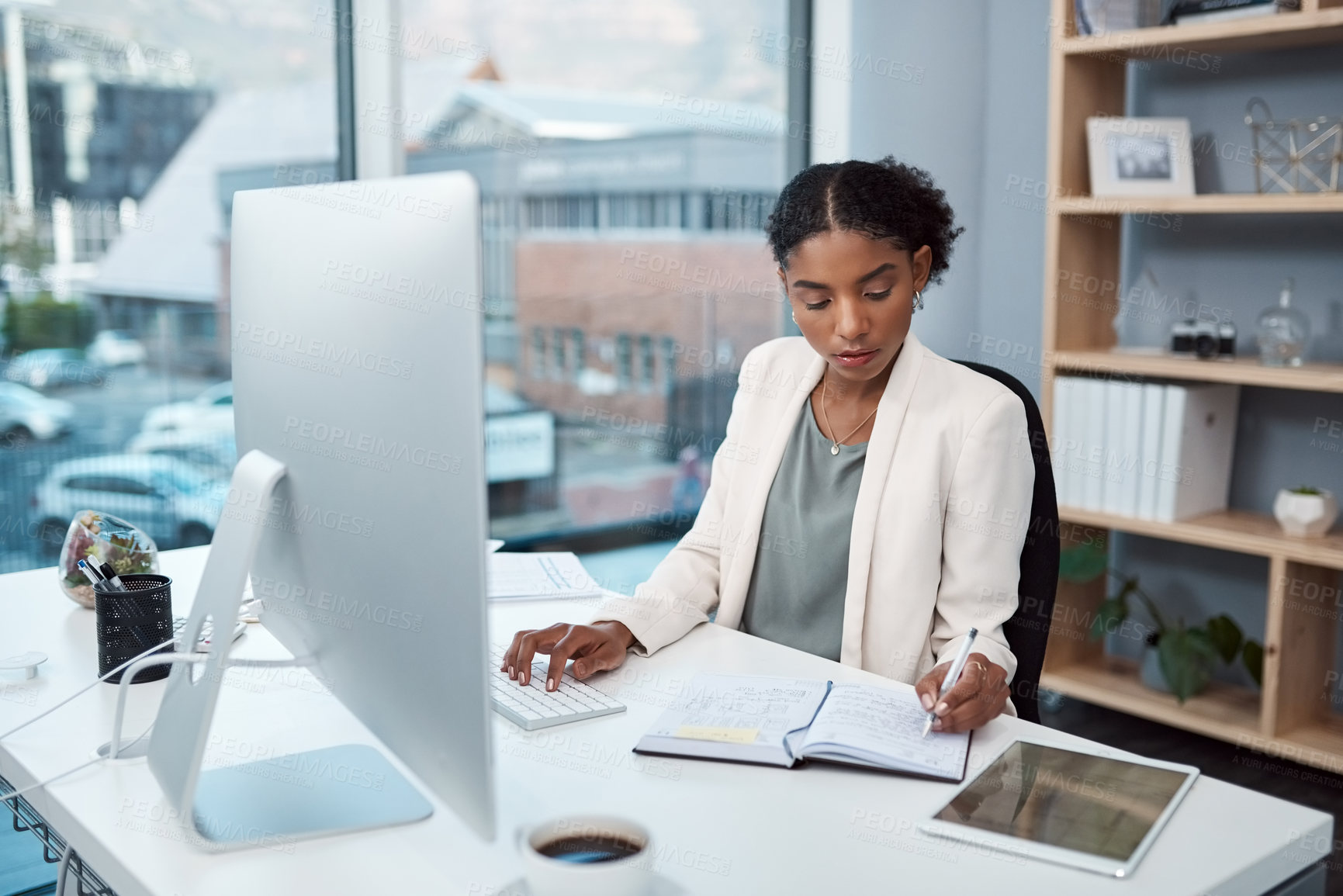 Buy stock photo Finance manager writing notes, typing on a computer keyboard and planning to check financial data in office. Serious boss thinking, arranging tax deadlines or scheduling business meetings in notebook