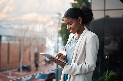 Buy stock photo Business woman on a digital tablet outside a modern office alone. Smiling corporate worker looking at web and social media posts on a balcony. Female employee on a touchscreen device with copy space.